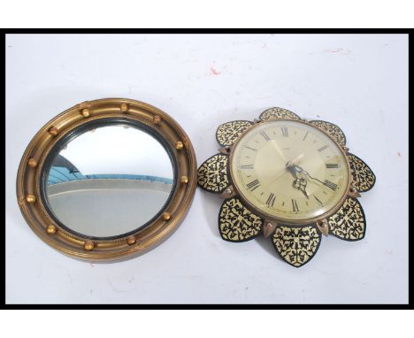 A 20th Century Metamec wall clock having a round face with a brushed yellow metal interior, having roman numerals to the chap