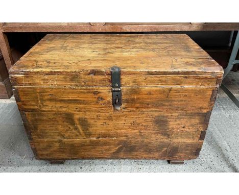 A 20th century pine trunk, with iron swing handles, 52cm high, 80cm long, 49cm wide 