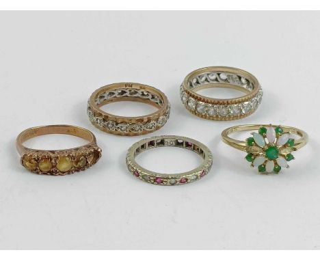 A 9 carat gold eternity ring; another similar; another unmarked; a 9 carat gold five stone citrine ring; and a 9 carat gold Q