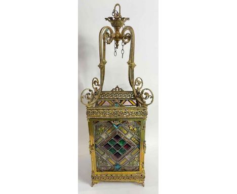 An Arts and Crafts stained glass hall lantern, with a brass frame, with four identical glass panels, 78cm high 