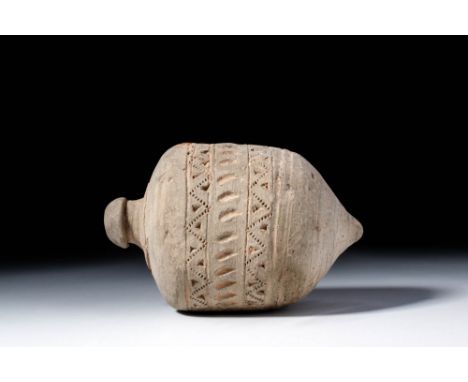 Ca. AD 900 - 1100. A cylindrical terracotta grenade with a lower body tapering to a pointed tip. The upper part gently rounds