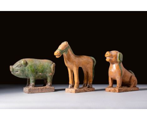 Ca. AD 1368 - 1644 or later. A collection of three glazed pottery zodiac animals. The first on the left is a pig with a round