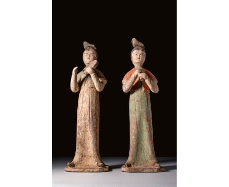 Ca. AD 618 - 907.A pair of female musician terracotta figures, both depicted standing upright with long flowing robes and hig