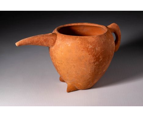 Ca. 1100 - 900 BC. A terracotta pitcher with a rounded body, open top, and pronounced elongated spout counterbalanced by a si