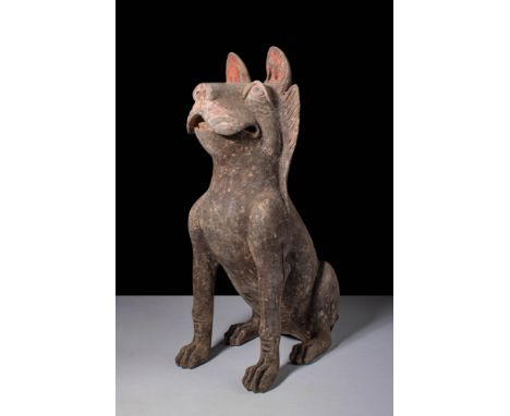 Ca. 202 BC - AD 220.A terracotta figure of a dog depicted seated with an upright posture, forelegs straight and rear legs ben