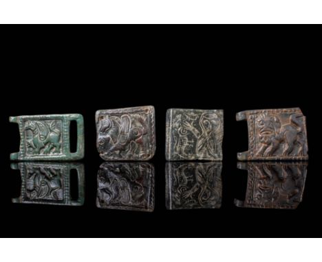 Ca. AD 900 - 1000. A collection of four bronze belt fittings, each rectangular in form and cast in low relief. The pieces dep