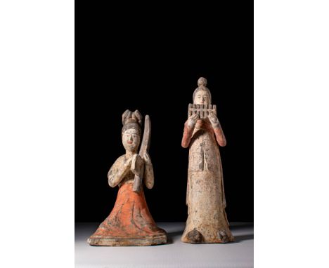 Ca. AD 618 - 907.A pair of female musician terracotta figures, one shown seated and the other standing. The seated figure pla