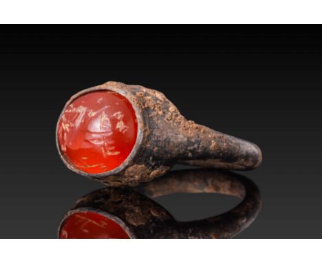 Ca. AD 200 - 602. A carnelian intaglio engraved with linear motifs set in an oval bezel of a plain silver ring.For similar se