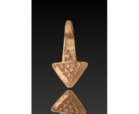 Ca. AD 900 - 1100. A gold Mjölnir pendant in the form of a stylised hammer with a broad, triangular head and tapering shaft s