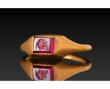 Ca. AD 1400 - 1600 .A gold stirrup-type ring with a narrow, rounded hoop that broadens at the shoulders into a flat, wedge-sh