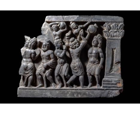 Ca. AD 2-3rd Century. A Gandharan stone panel, depicting a celebratory or festive scene. The panel presents a procession of m