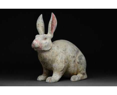 Ca. 202 BC - AD 220.A moulded terracotta figure of a crouching rabbit with upright ears and rounded haunches. The body is com