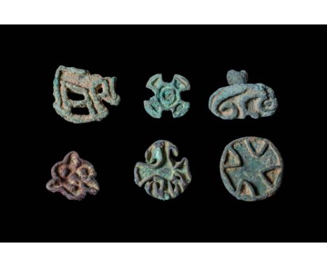 Ca. 2300 - 1800 BC. A collection of six bronze stamp seals. One is roughly oval with a flat face engraved with a linear patte