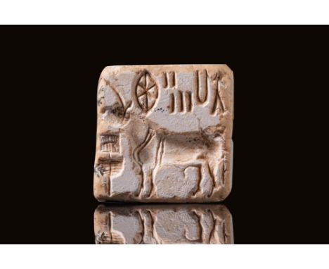 Ca. 2300 BC. A square plaque with a suspension loop of one piece on the back. The design on the face shows a standing "bison"