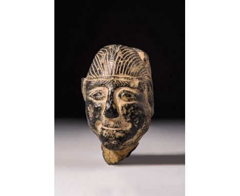 Ca. 2500 - 2000 BC. A finely carved from a black stone with a high polish, this sculptural head represents a male figure, pos