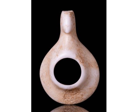 Ca. 3000 - 2500 BC. A Sumerian finely carved stone amulet depicting a stylised bird with a tapering beak and incised circular