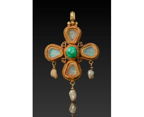 Ca. AD 600.A gold cross pendant centred with a domed emerald set within a beaded border. Each arm is mounted with a drop-shap