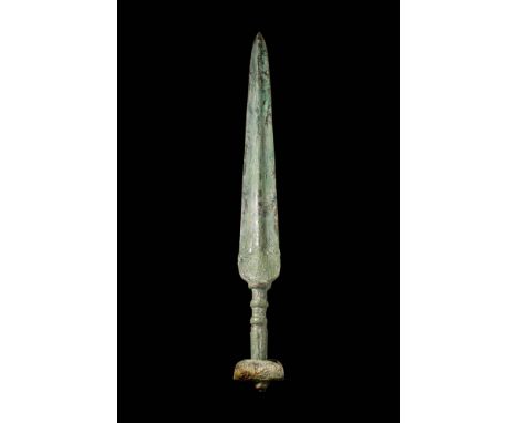 Ca. 1200 - 800 BC.A cast bronze sword with a sharply tapering blade and a raised central ridge running the full length to a p