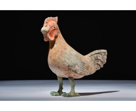 Ca. 202 BC - AD 220.A polychrome terracotta rooster with a hollow body, incised wings, and a layered tail. The head is held u