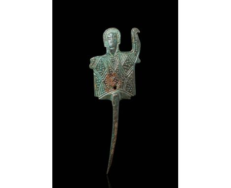 Ca. AD 800 - 1100. A cast bronze amulet in the form of a bust of a male figure with a rectangular torso, elongated head, and 