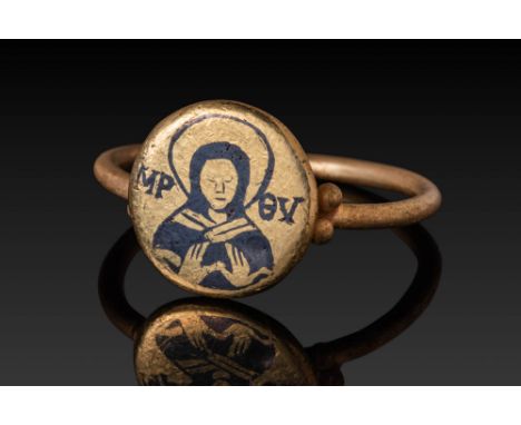 Ca. AD 600. A gold ring with a circular bezel inlaid with niello, depicting the Virgin Mary in bust form, shown frontally wit