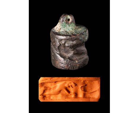 Ca. 3rd - 2nd millennium BC.A dark stone cylinder seal, possibly from Elam or Bactria, retaining its original bronze loop and