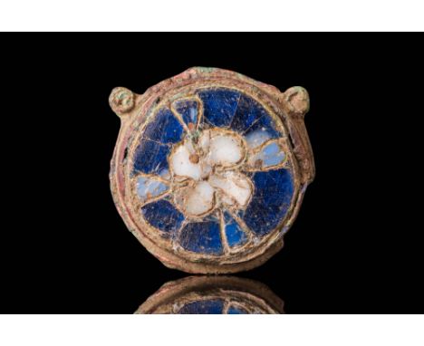 Ca. AD 1000 - 1100. A circular bronze brooch decorated in cloisonné technique with a central motif of a four-petalled flower 