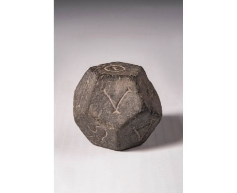 Ca. AD 300 - 500.A dark stone polyhedral die with each face engraved with a different letter.For similar see: The Harvard Art