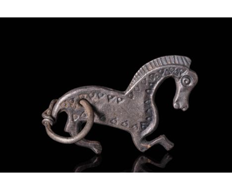 Ca. AD 800 - 1000. A silver pendant cast in the form of a stylised horse with a rounded body and arched neck. The upper face 