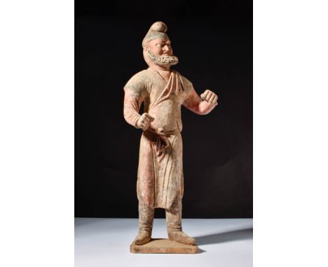 Ca. AD 618 - 907.A large terracotta figure representing a standing Sogdian merchant with exaggerated facial features, includi