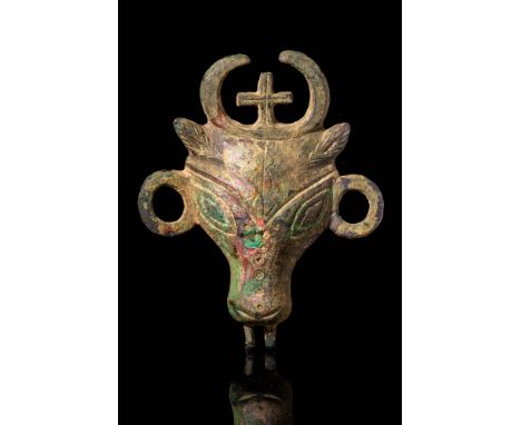 Ca. AD 600 - 800. A miniature applique in cast bronze, depicting the bull of St. Luke with nice horns and ears splayed out fr