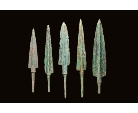 Ca. 1200 - 1000 BC. A carefully curated selection of socketed bronze arrowheads is presented, each featuring a central midrib