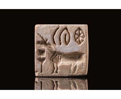 Ca. 2300 BC. A square plaque with pierced handle on the back, of one piece. The design on the face shows a standing "bison" w