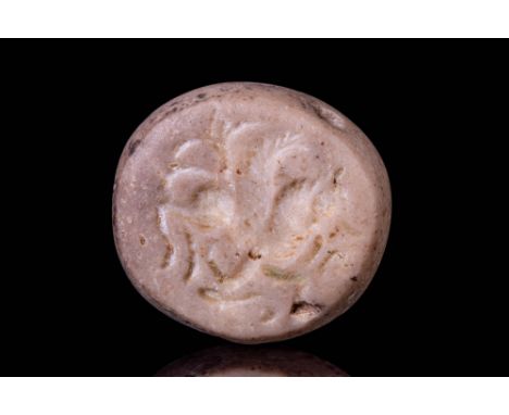 Ca. AD 200 - 600. A light brown stone seal engraved with a winged horse in profile, its head raised and one foreleg lifted. T