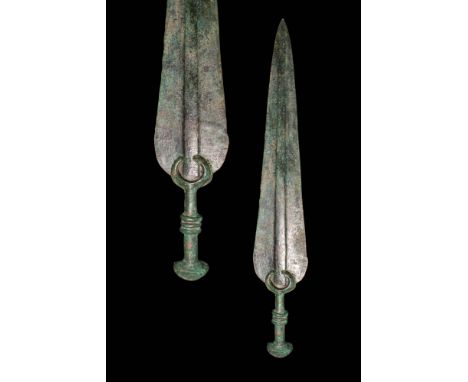 Ca. 1000 - 800 BC. A bronze sword with a long blade cast separately and fitted into a hilt with a crescent-shaped guard, ribb