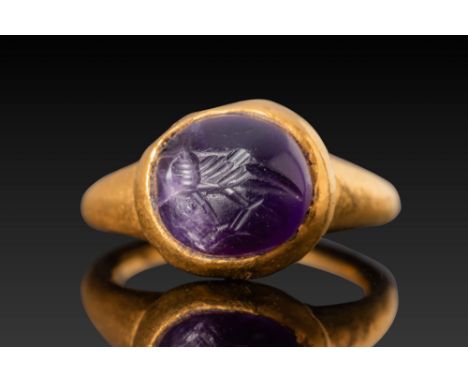 Ca. AD 500. A gold ring set with an amethyst intaglio engraved with a bird in profile. The amethyst is held in a plain high-w