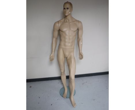 A shop mannequin on brass stand 