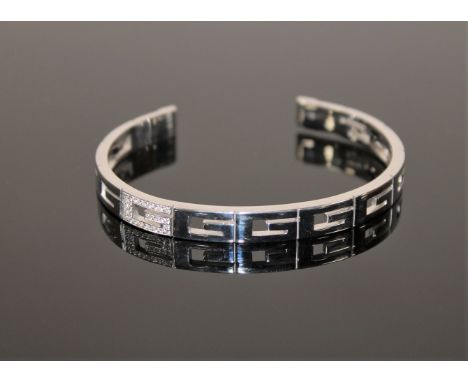 An 18ct gold diamond set bangle by Gucci, 28.2g (Cost £2,800 new) 