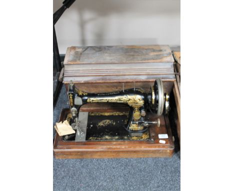 A mahogany cased vintage hand sewing machine 