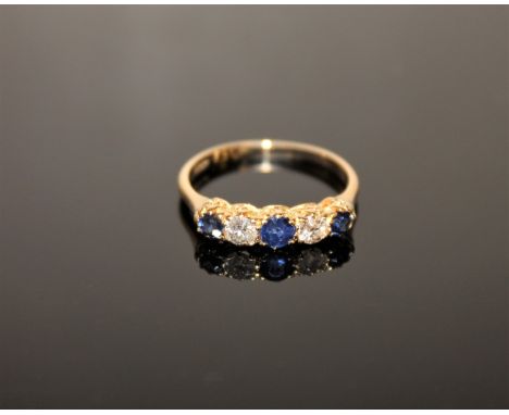 An 18ct gold five stone sapphire and diamond ring