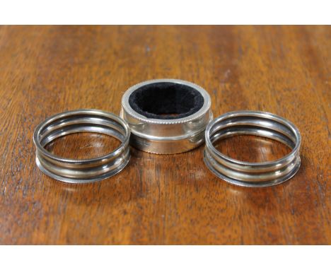 A pair of silver napkin rings together with one other sterling silver napkin ring (3)