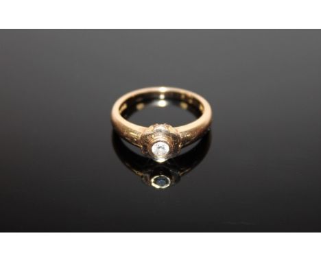 An 18ct gold ring set with a .15 solitaire diamond, 4.3g