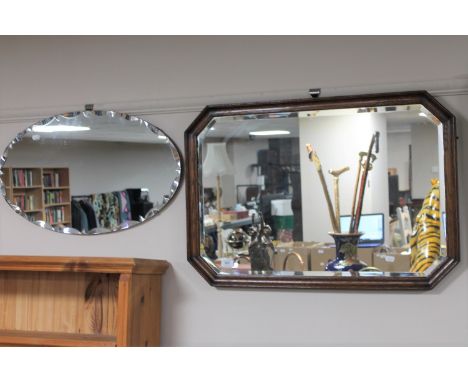 An Edwardian octagonal oak framed mirror and an un-framed mirror 