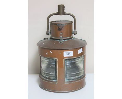 A copper ship's light stamped 1942 CONDITION REPORT: There is no burner or a later light bulb within the lamp. It has not bee