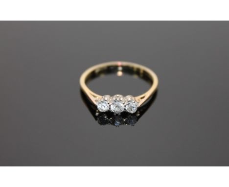 An 18ct gold three stone diamond ring, size O.