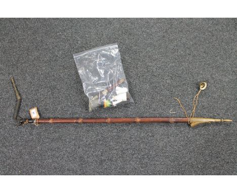 A long handled smoking pipe with ceramic bowl together with one other