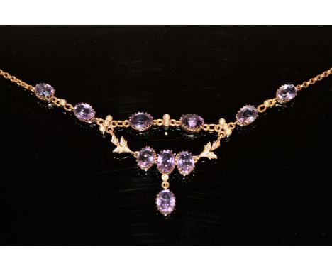 An antique yellow metal necklace set with amethyst and seed pearls