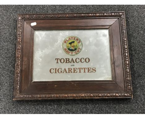 An early 20th century and later oak framed mirror bearing "Player's Navy Cut Tobacco" advertisement 