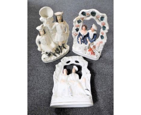 A pair of Staffordshire flat backed figures - Figures seated on a bench together with a Staffordshire spill vase 