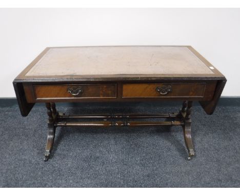 A mahogany leather topped sofa table 